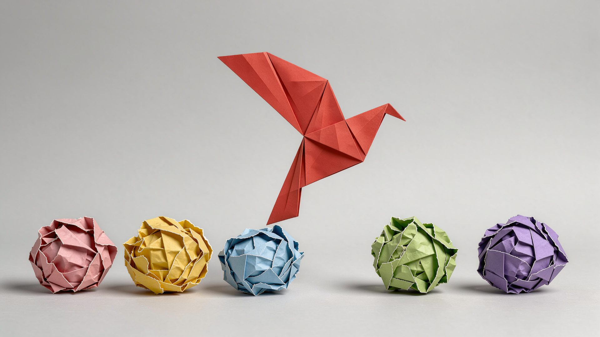 Red origami bird rising from crumpled paper – web design in Nelspruit by Spectrum Designs